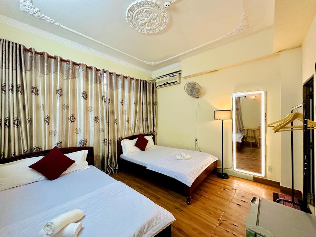 Postel nebo postele na pokoji v ubytování Thanh Huyền Hotel Vũng Tàu