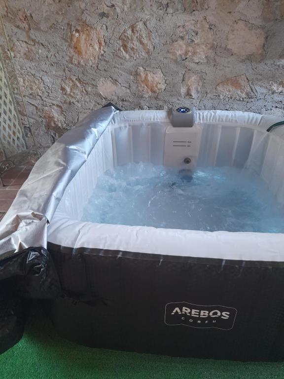 a large hot tub in front of a stone wall at Beb san giorgio in Volpino