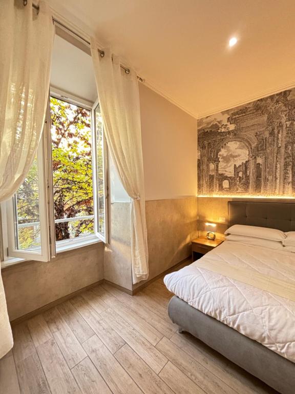 a bedroom with a bed and a painting on the wall at Casa Mirabilia in Rome