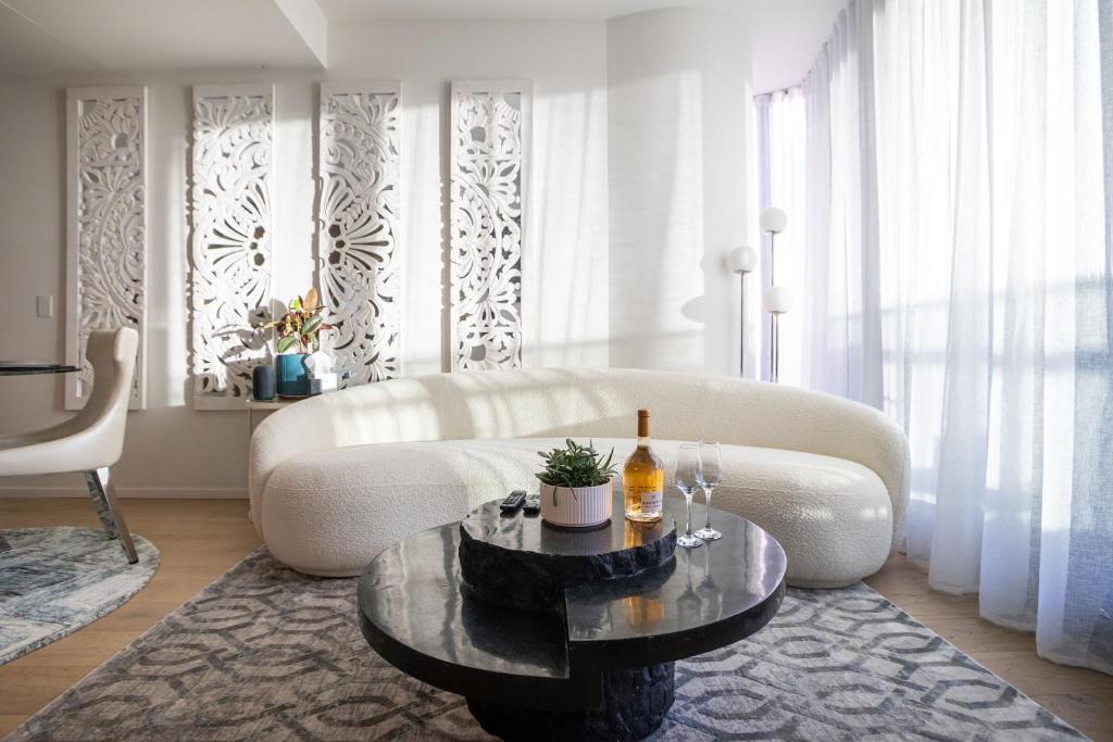 a living room with a white couch and a table at The Cosmopolitan Crown in Melbourne