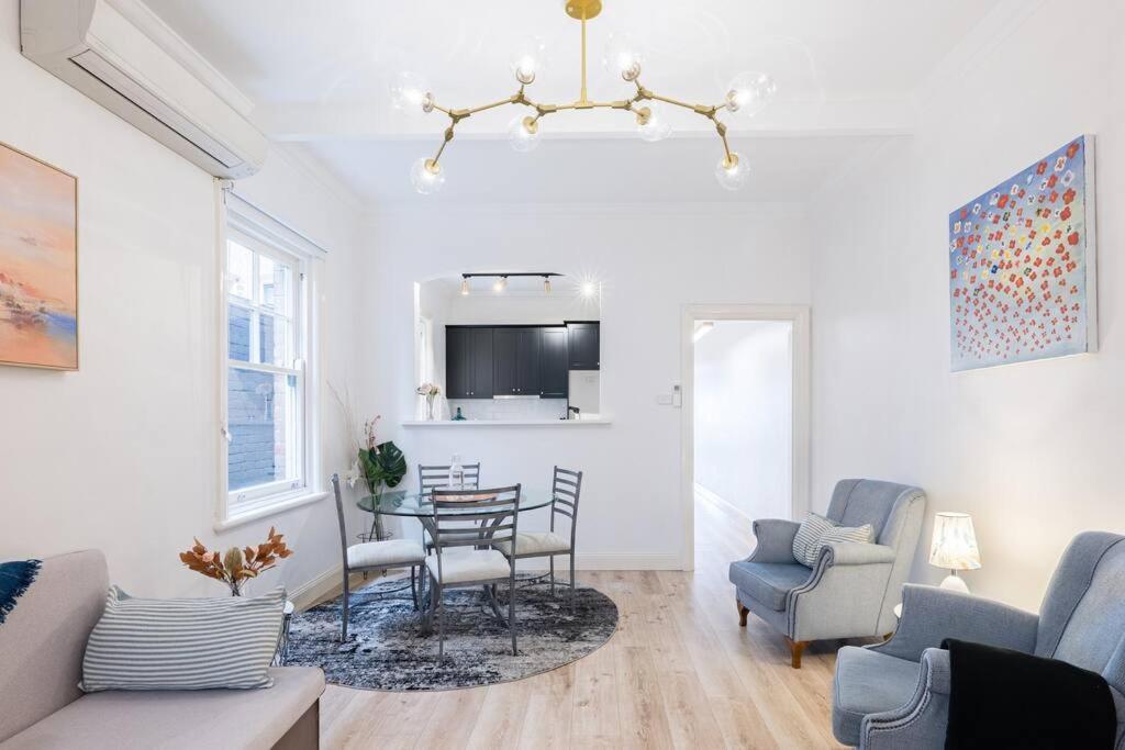 a living room with a table and chairs at Cozy King Suite Millers Point in Sydney