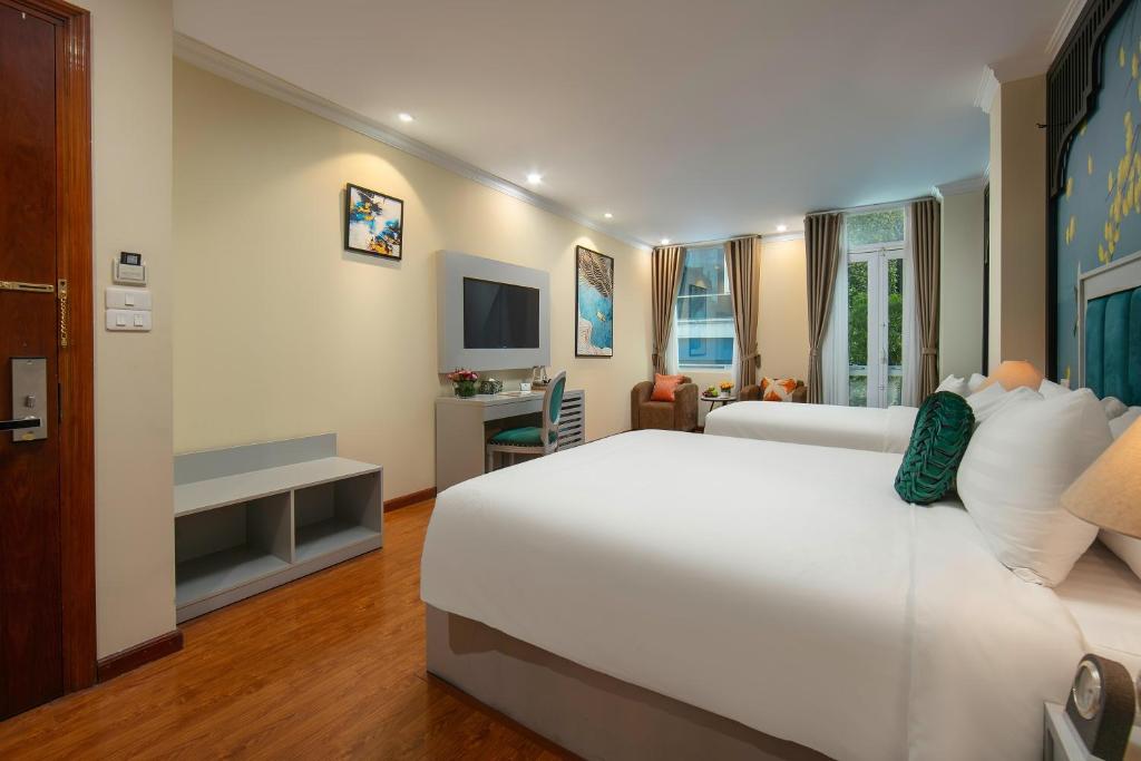 Postel nebo postele na pokoji v ubytování Serenata San de Hanoi Hotel