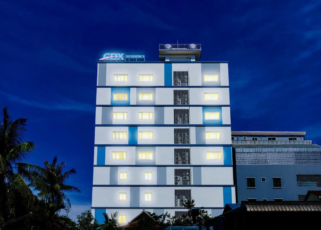 a tall white building with lights on top of it at CDX RESIDENCE in Phnom Penh