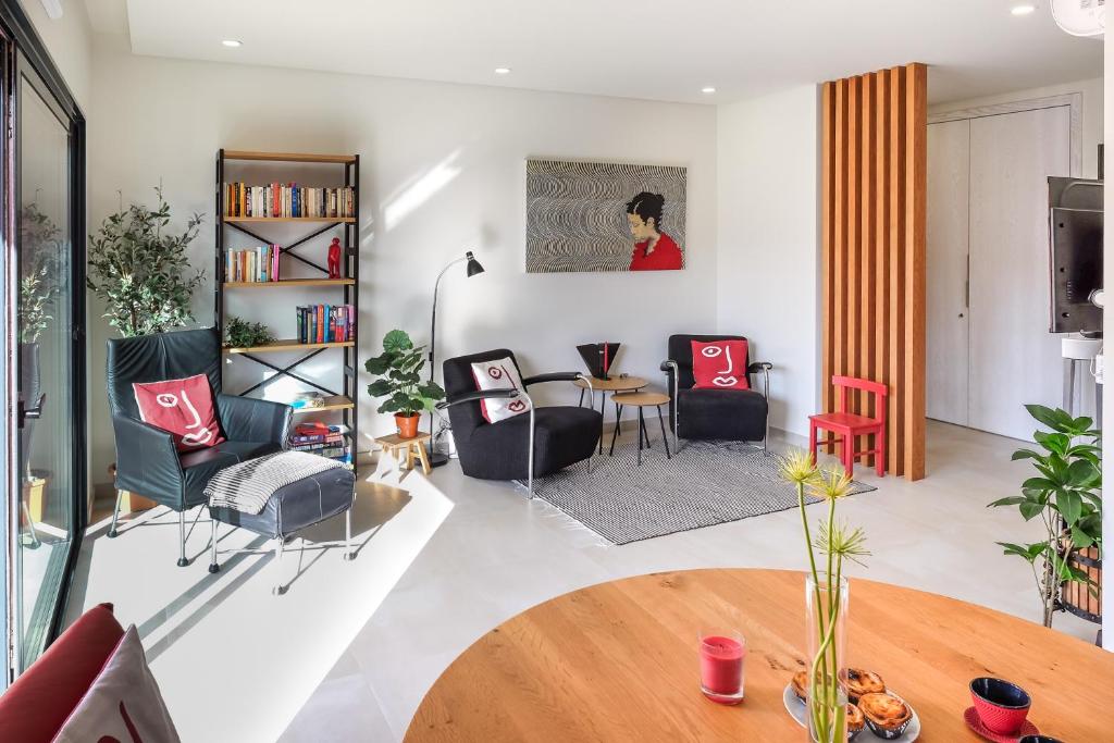 a living room with a table and chairs at Taste Tavira (by Annick) fully equipped apartment, tastefully decorated, perfect location and free parkingric center of the city of Tavira. in Tavira