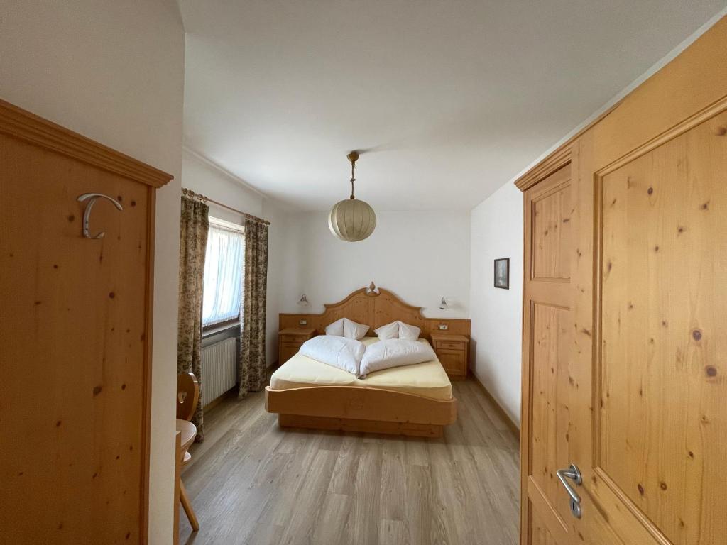 a bedroom with a bed with white pillows at Apartment Gertrud in Castelrotto