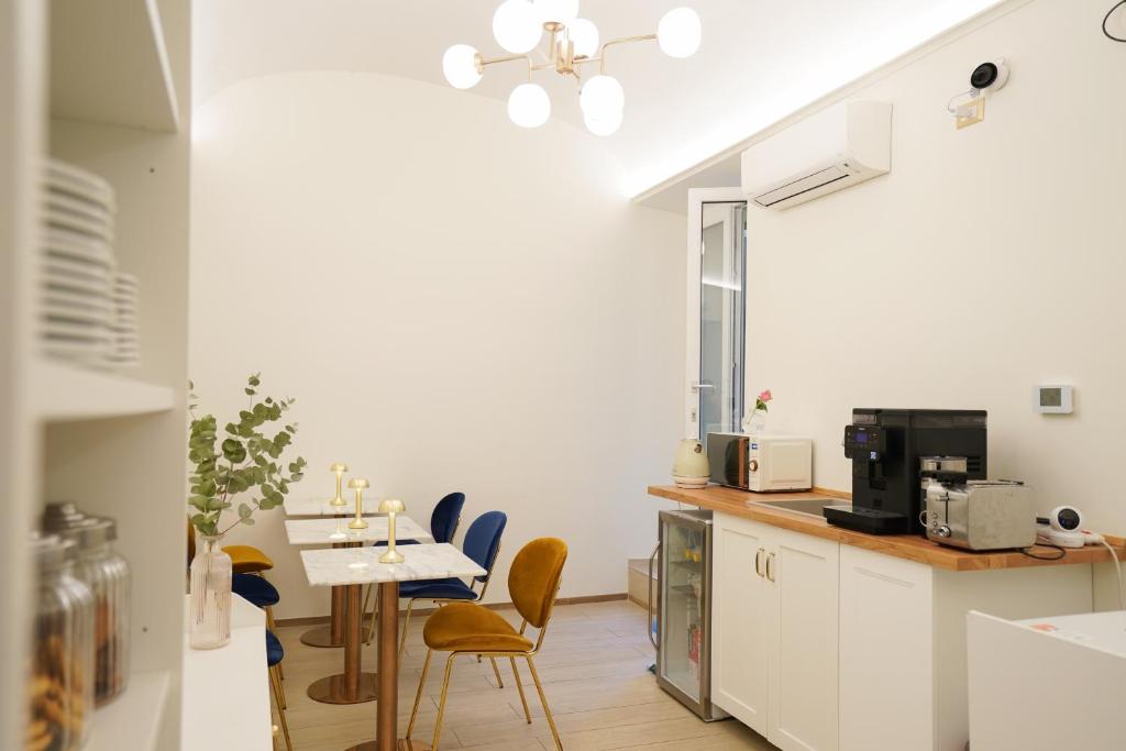 a kitchen with a table and chairs in a room at Charm&Bella GuestHouse in Rome