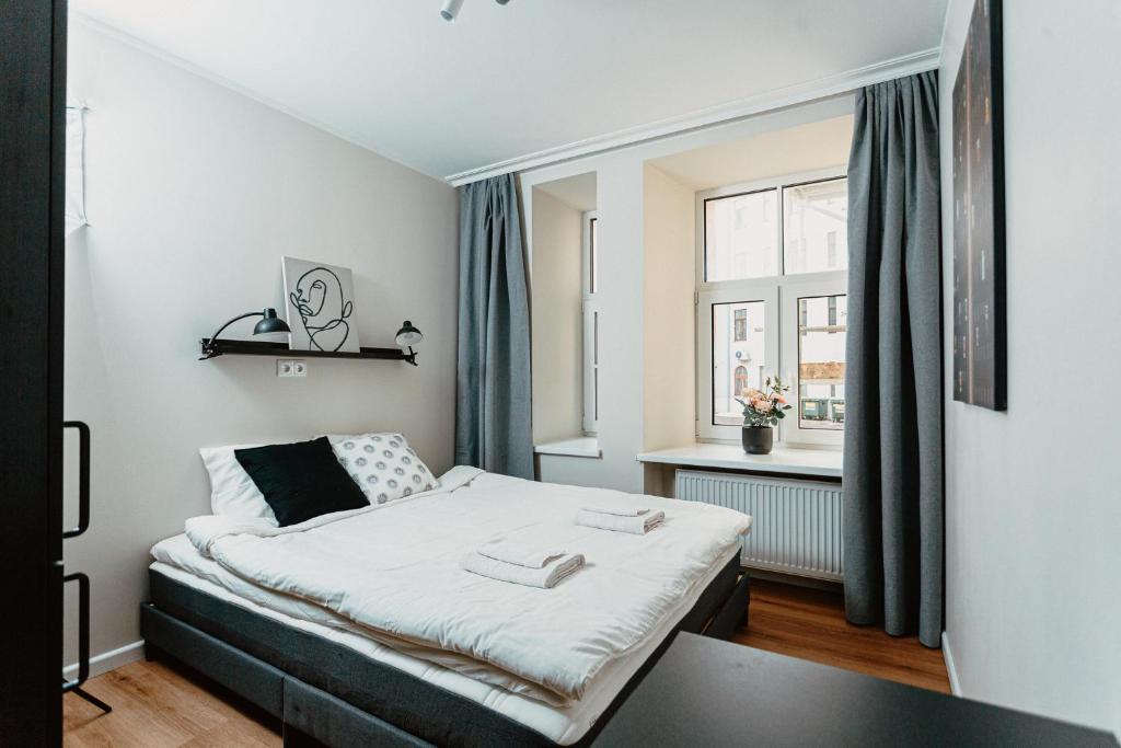 a small bedroom with a bed and a window at Cosy Central Studio Apt. - Near Old Town in Riga