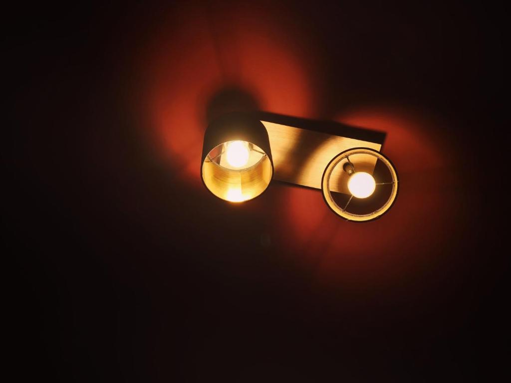a light fixture hanging in a dark room at THE BLACKTAGON Cozy Room in Frankfurt