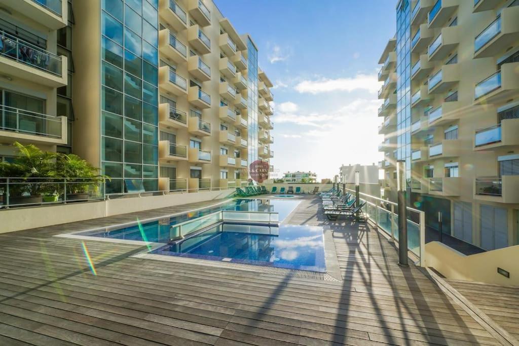 a swimming pool in the middle of a building at Vista Mar Concórdia by Rentallido in Funchal