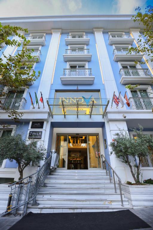 a large white building with stairs leading to the entrance at Innova Sultanahmet Istanbul in Istanbul