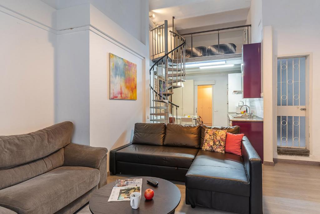 a living room with a couch and a table at AB Modern Gracia Apartment in Barcelona