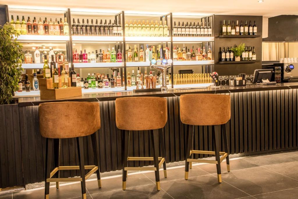 a bar with two chairs in front of it at Park Inn by Radisson Bournemouth in Bournemouth