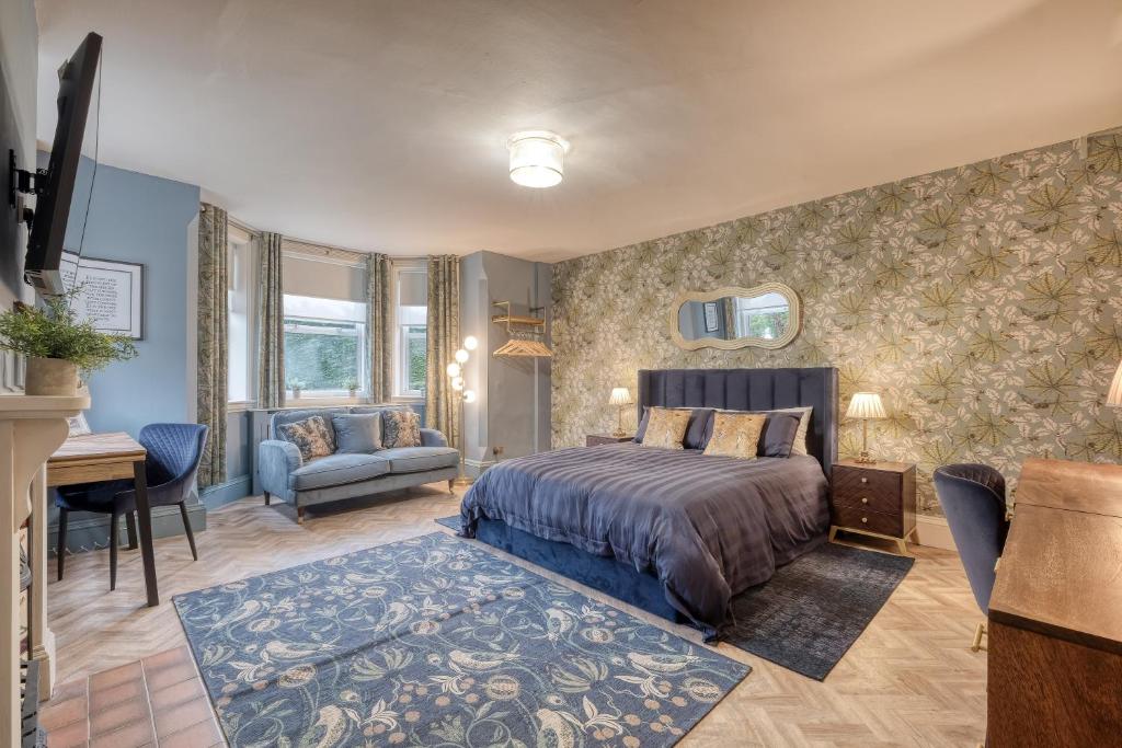 a bedroom with a bed and a desk at The Darwin Malvern Suite in Great Malvern