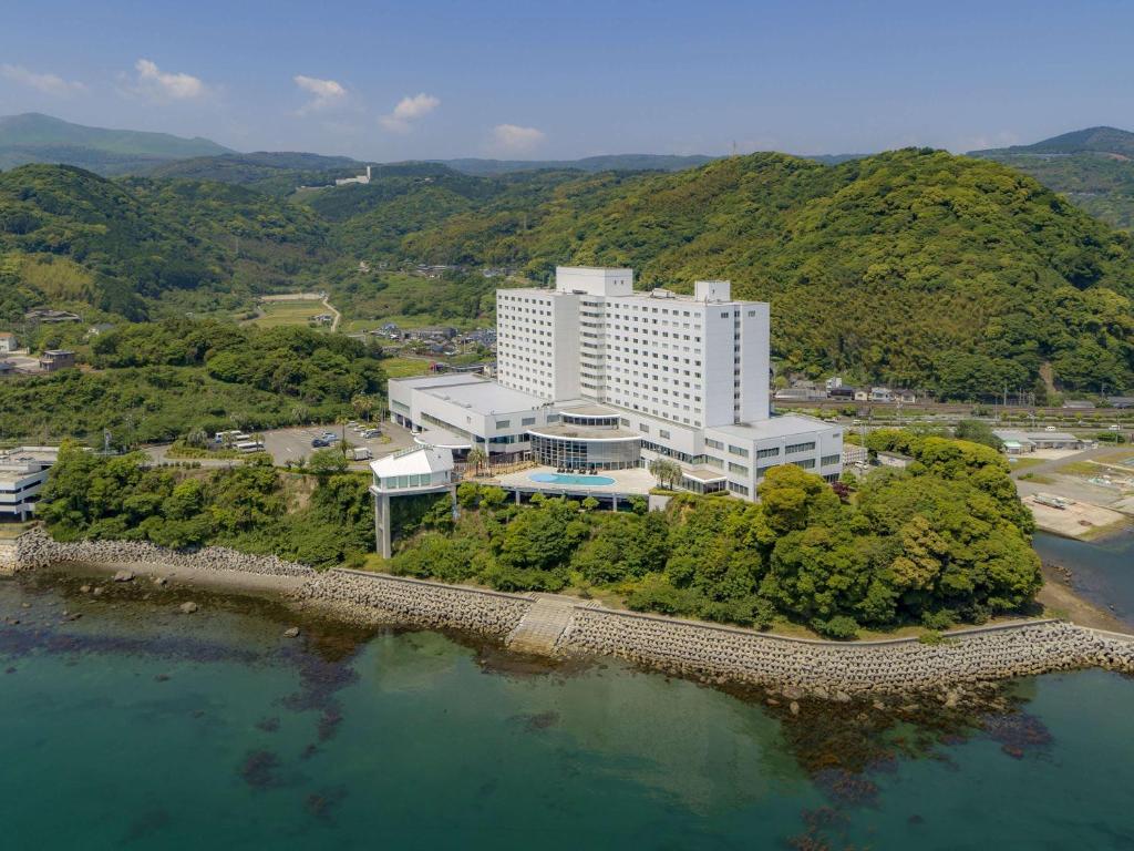 an aerial view of a building on an island in the water at Grand Mercure Beppu Bay Resort & Spa in Beppu