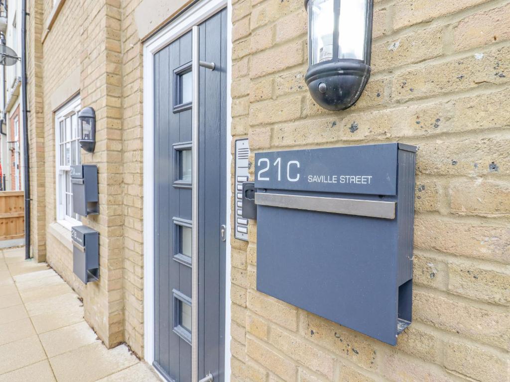 a street sign on the side of a brick building at 21C Saville Road in Walton-on-the-Naze