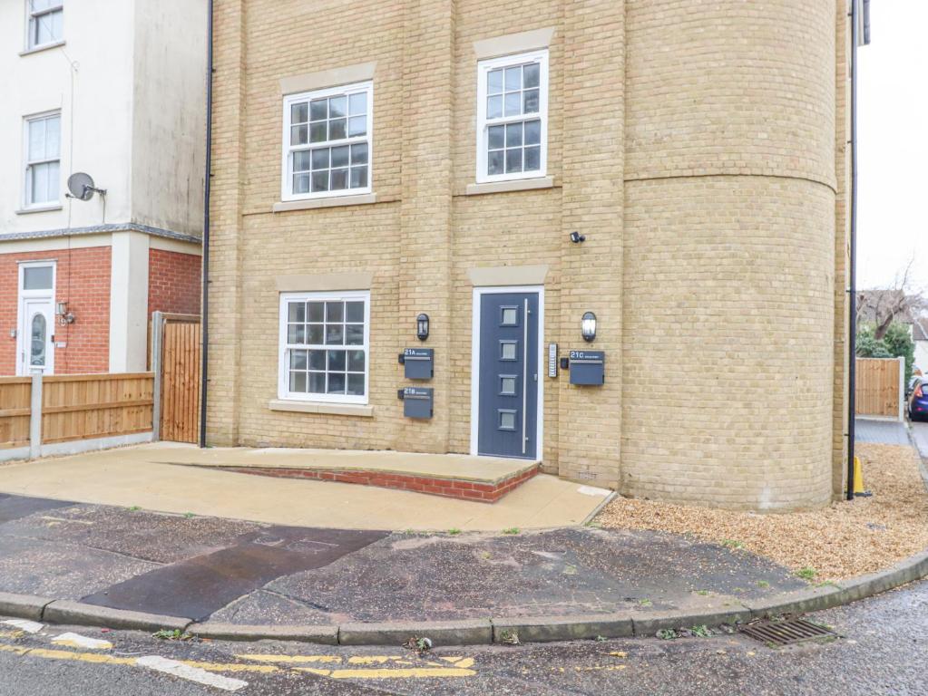 a building with a blue door on the side of it at 21A Saville Road in Walton-on-the-Naze