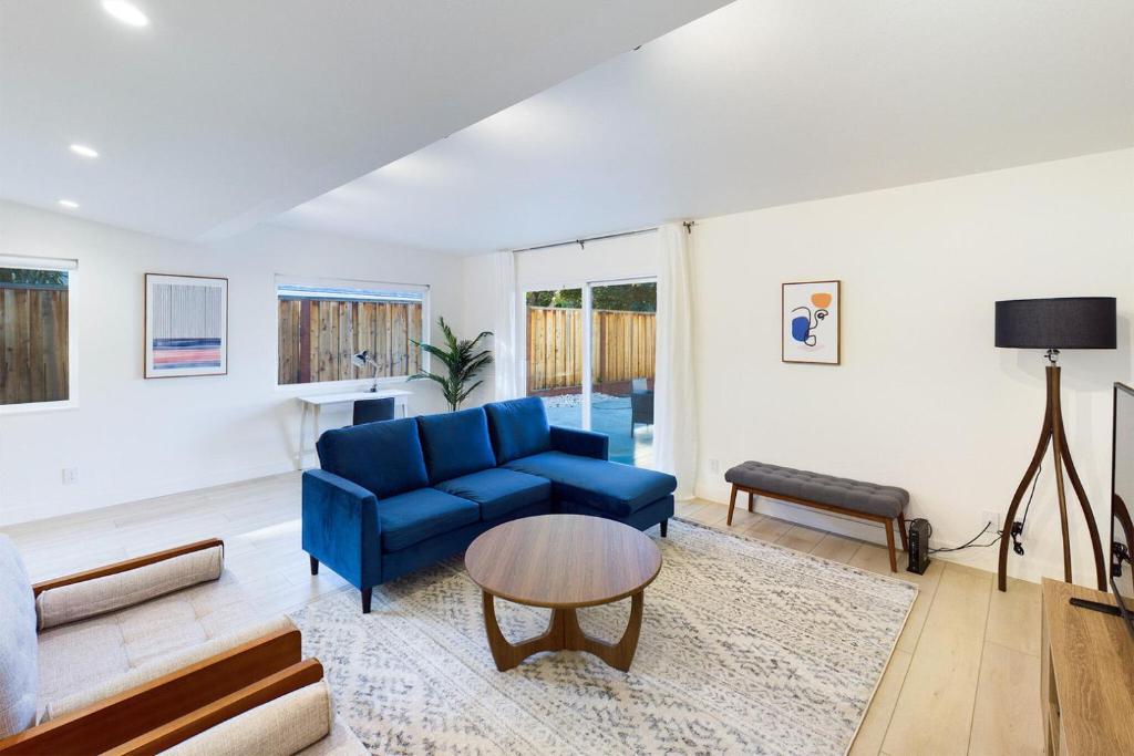 a living room with a blue couch and a table at Cupertino 3br w patio backyard nr restaurants SFO-1636 in Cupertino