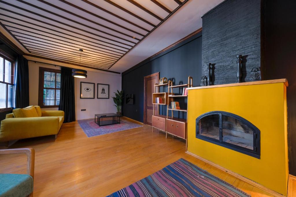 a living room with a yellow fire place at The Kosk -5Br Villa with Turkish Bath- City Centre in Istanbul