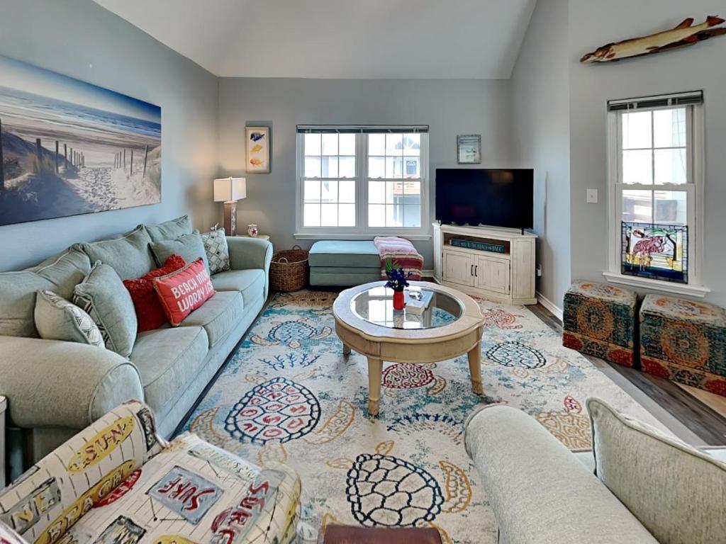 a living room with a couch and a table at Beach Place in Port Aransas