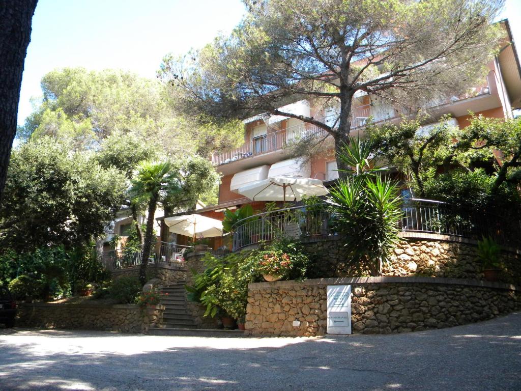 a building with stairs in front of it at Hotel Rosa Del Tirreno in Quercianella