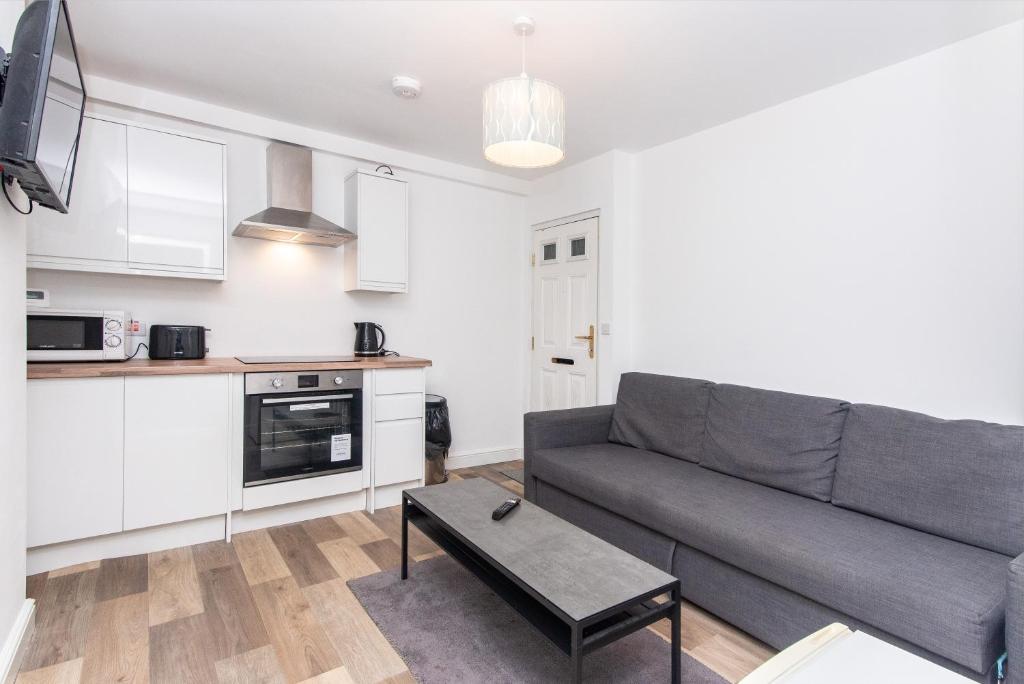 a living room with a couch and a table at 1-BR Gem in Sheffield - Easy City Centre Access in Sheffield