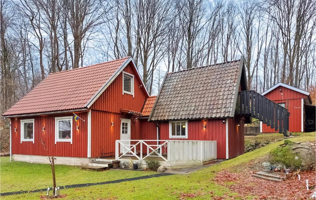 two red barns with trees in the background at 1 Bedroom Awesome Home In Ljungbyhed in Ljungbyhed