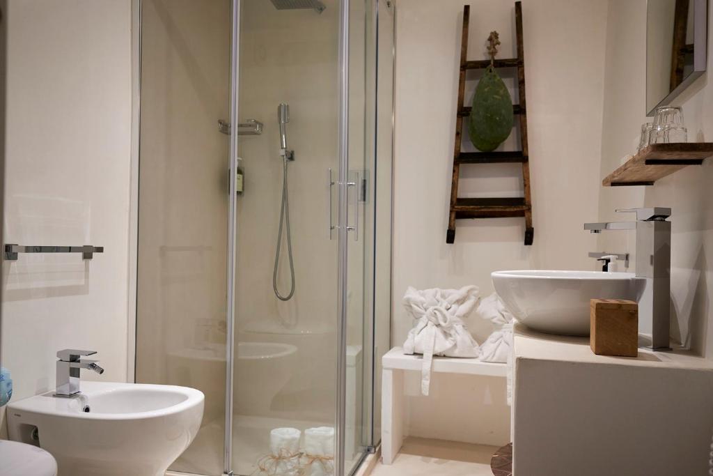 a bathroom with a shower and a toilet and a sink at Dei Serafini in Polignano a Mare