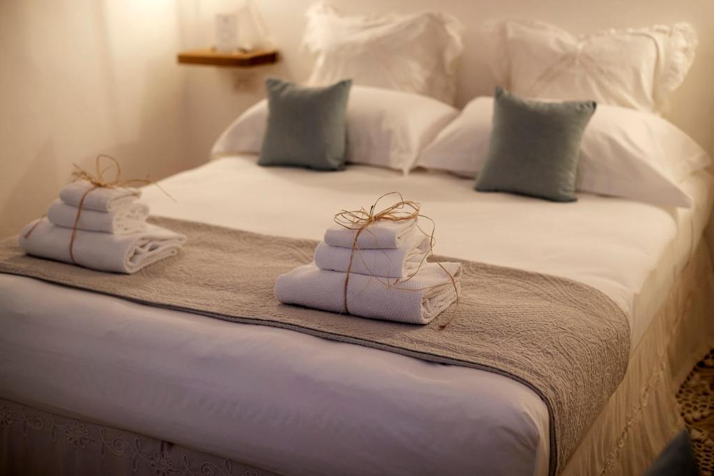 a bed with two towels on top of it at Dei Serafini in Polignano a Mare