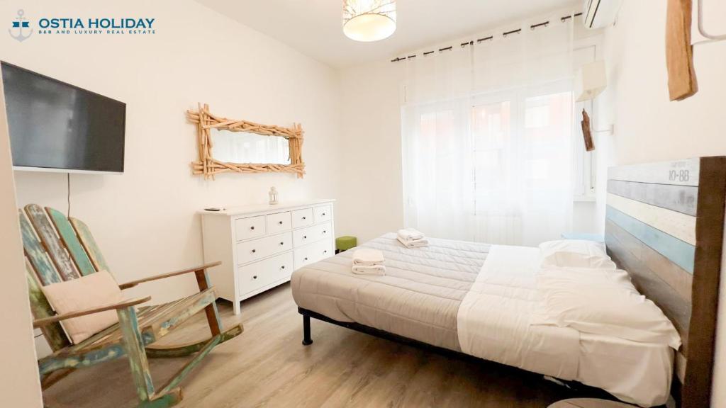 a bedroom with a bed and a dresser and a television at Appartamento Tramontana in Lido di Ostia