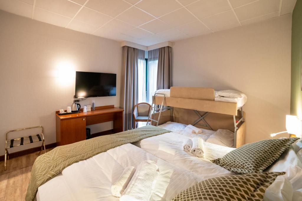 Łóżko lub łóżka w pokoju w obiekcie Hotel all'Orso