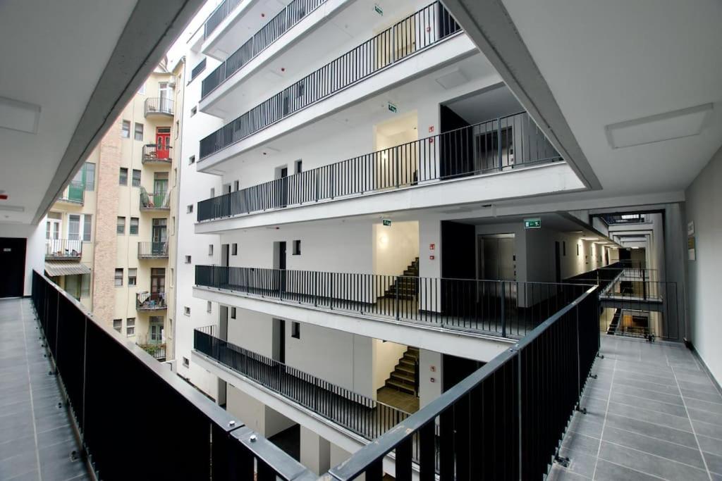 a view of a building with balconies and stairs at Standard Apartment by Hi5-Horváth Mihály square in Budapest