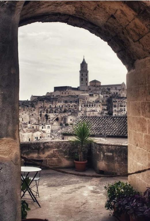 a view of a city from an arch way at Martini Matera 2-luxury apartment in Matera