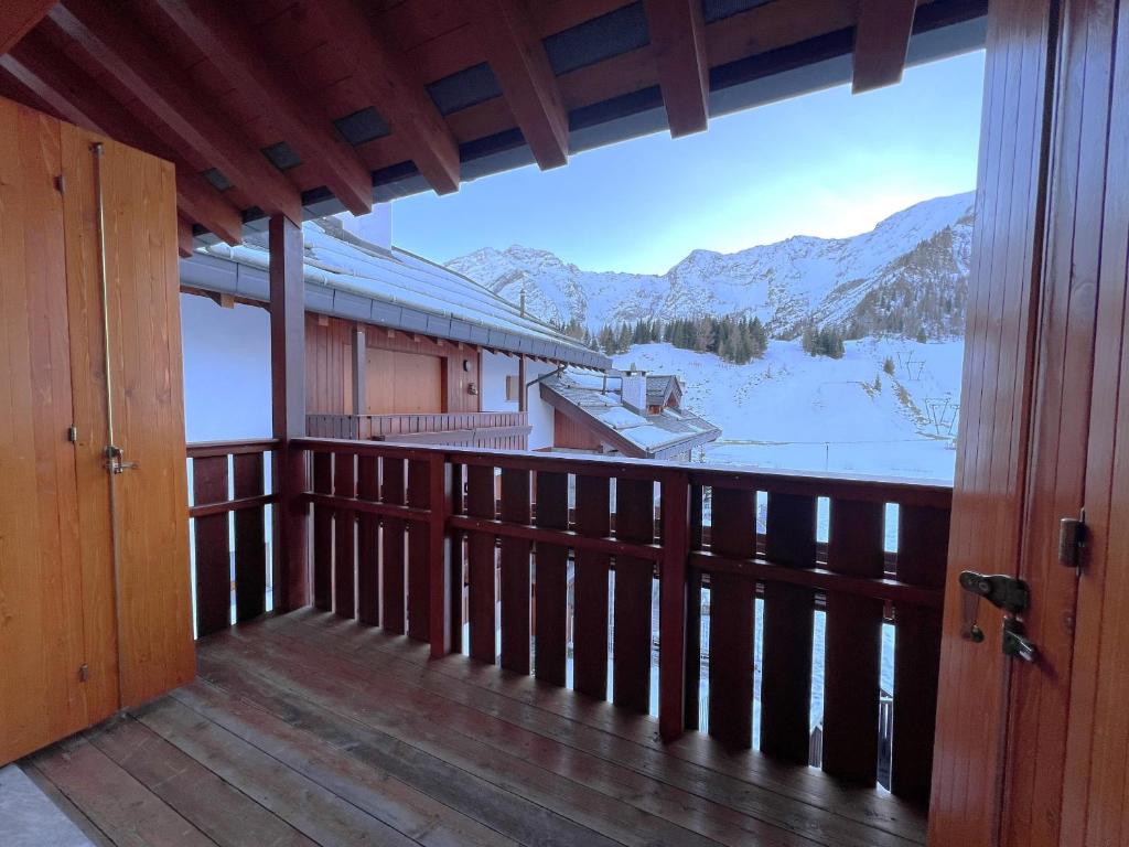 a balcony with a view of a snow covered mountain at Affittimoderni San Simone - VALS30 in Valleve