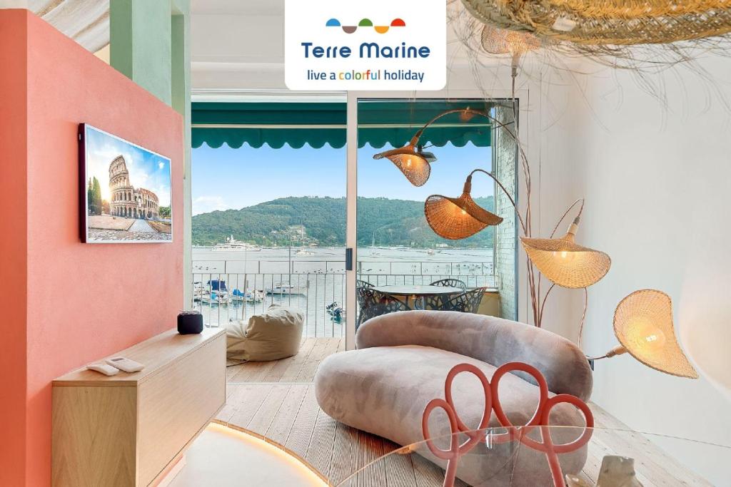 a living room with a couch and a large window at Riflessi di Mare, TerreMarine in Portovenere