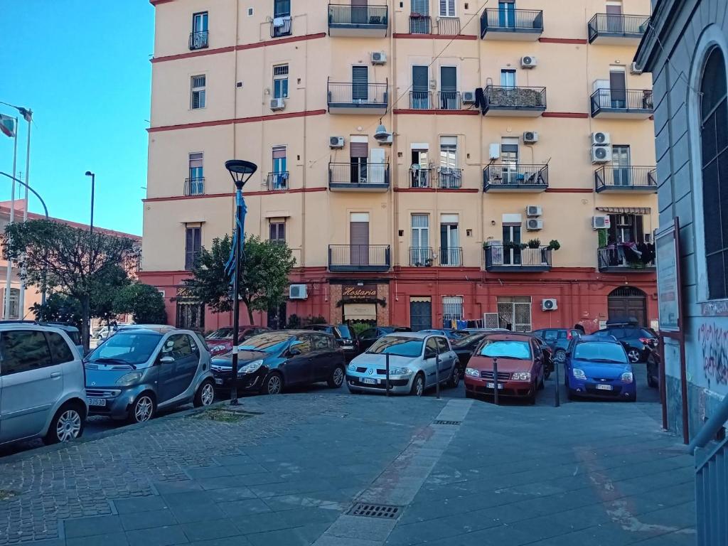 a parking lot with cars parked in front of a building at B&B di Kekka in Naples