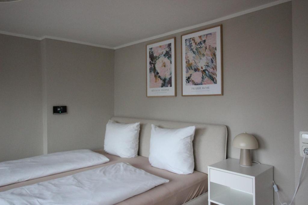 a hotel room with a bed with white pillows at Moderne Dachgeschosswohnung mit 2 Schlafzimmern in Würzburg