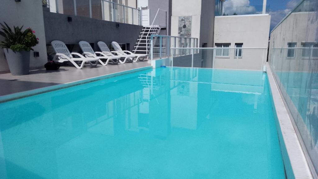 a swimming pool with lounge chairs in a building at B&B Unique in Salta