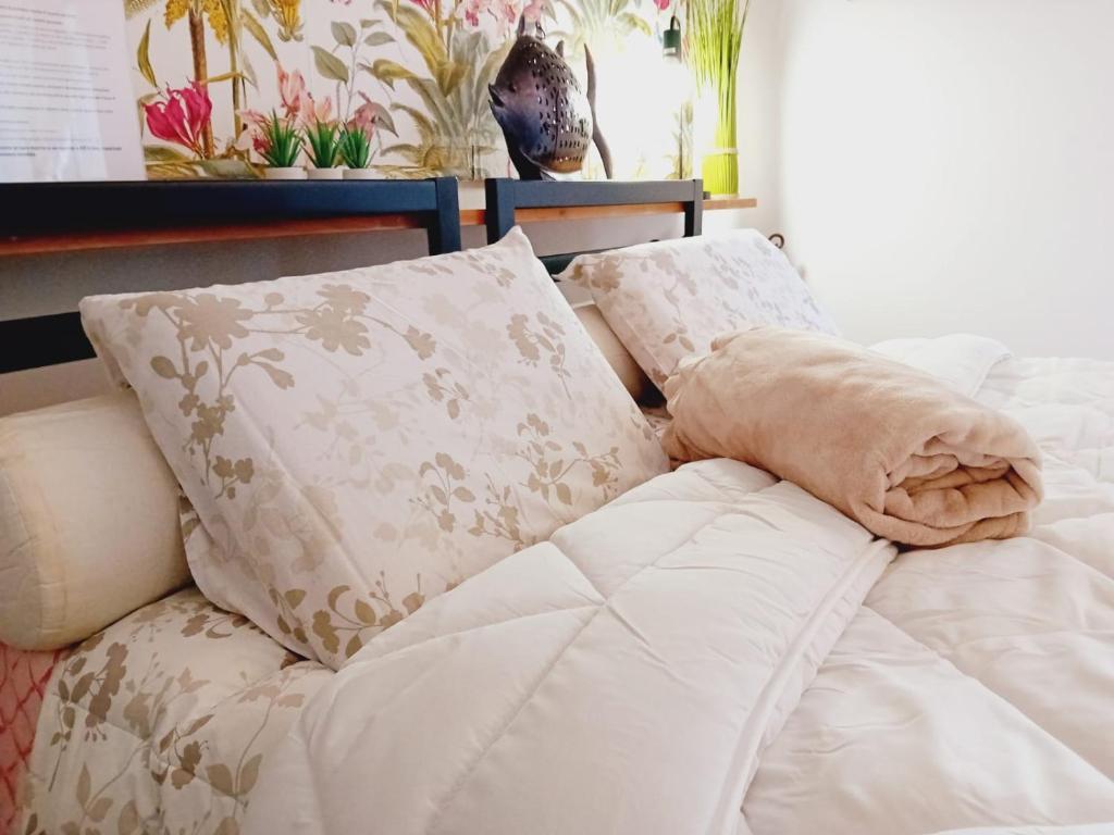 a white couch with two pillows on top of it at B&B La Delice in Dalmine