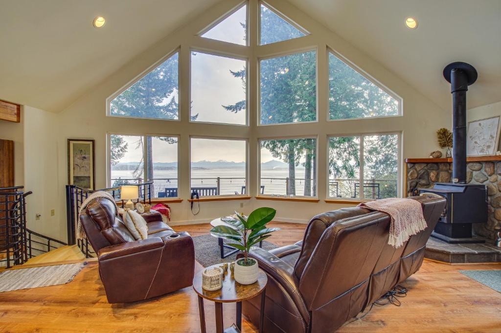 ein Wohnzimmer mit 2 Ledersesseln und einem Kamin in der Unterkunft Hat Island Home with Stunning View and Wraparound Deck in Everett