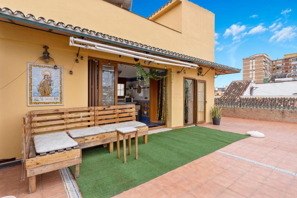 a patio with a bench and artificial grass at Villa Soler House in Malaga by Costarentals - MAL03 in Málaga