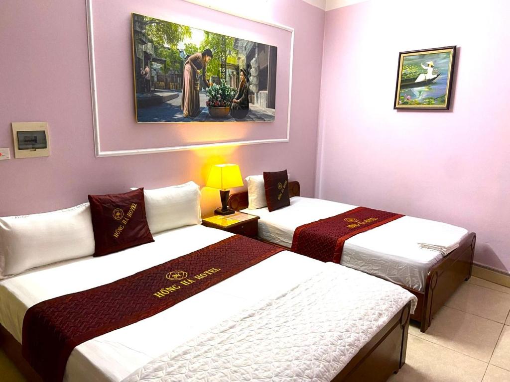 Postel nebo postele na pokoji v ubytování Hong Ha Airport Hotel