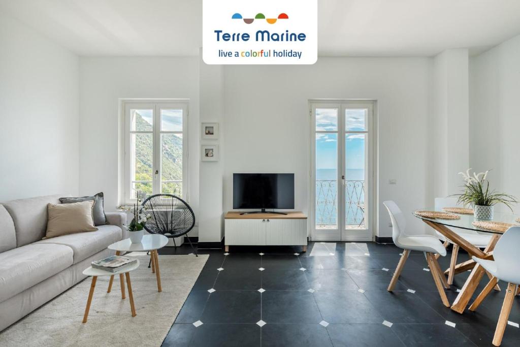 a living room with a couch and a tv at Sea Breeze Flat, Terre Marine in Corniglia