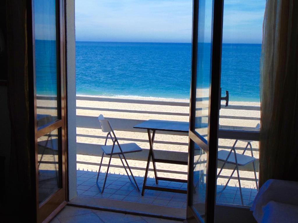 a view of the beach from a room with a table and chairs at Trilocale fronte mare a Marcelli - M210 in Marcelli