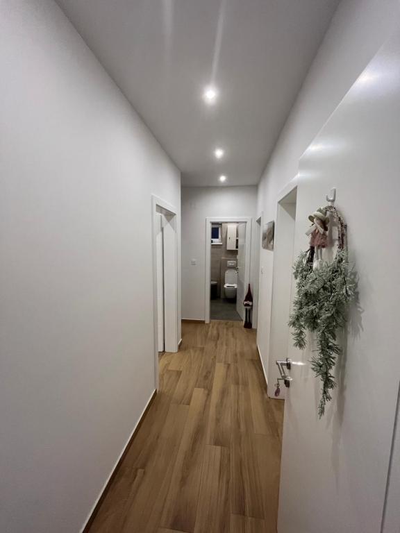 a hallway of a home with white walls and wood floors at Marina 2 in Sesvete