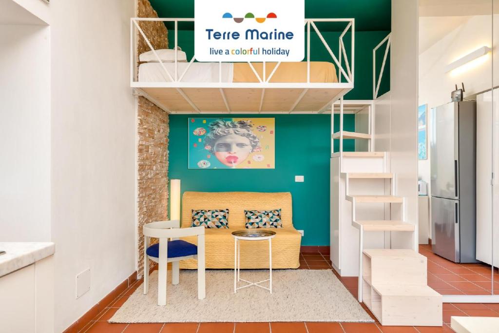 a room with a kitchen with a table and a staircase at Sunset Lovers, Terre Marine in San Bernardino