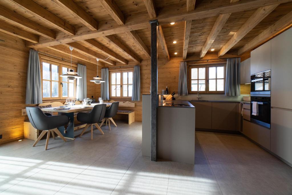 a kitchen and dining room with a table and chairs at Chalet Gamserrugg in Wildhaus