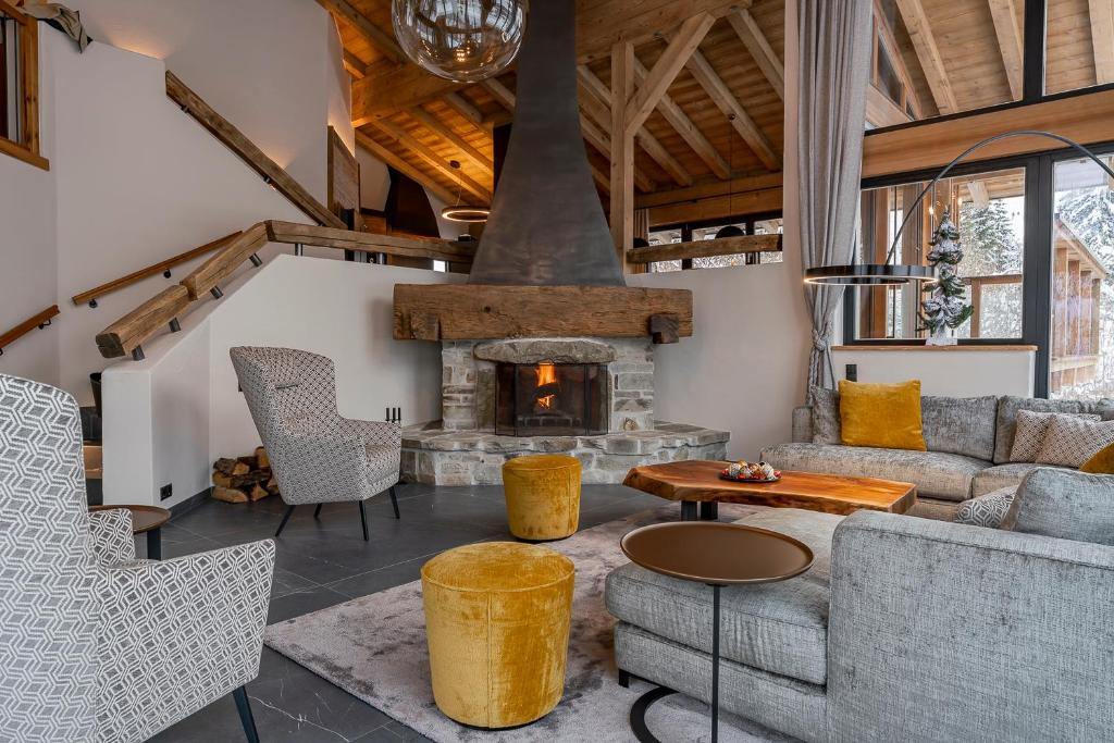 an open living room with a stone fireplace at Chalet VIE in Viehhofen