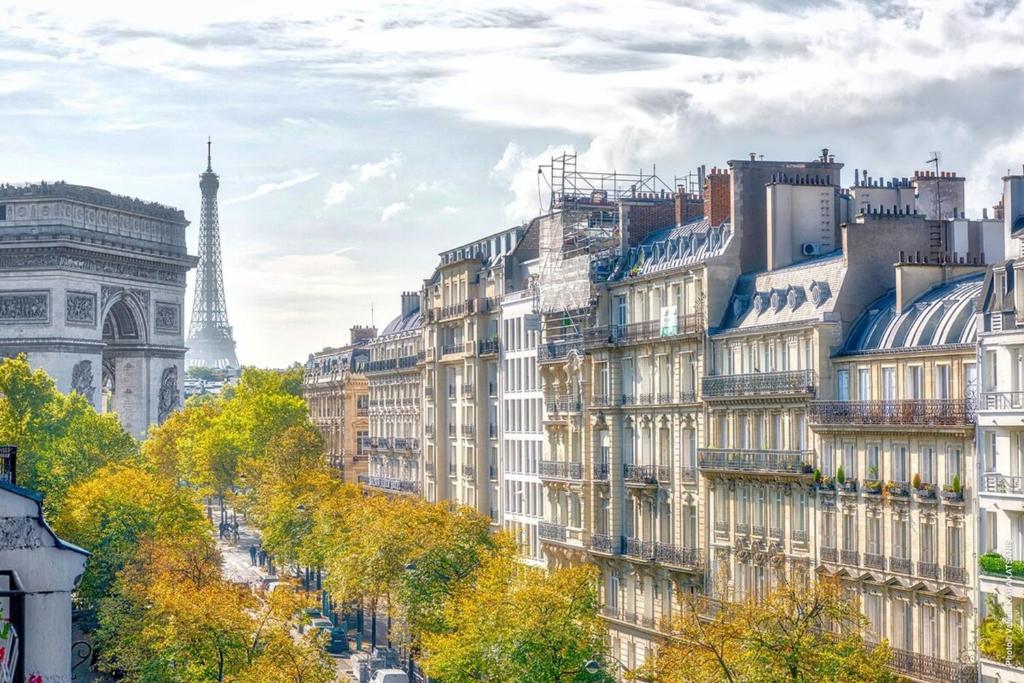 a cityscape of buildings in paris with the eiffel tower at Studio Mac Mahon - Champs Elysees in Paris