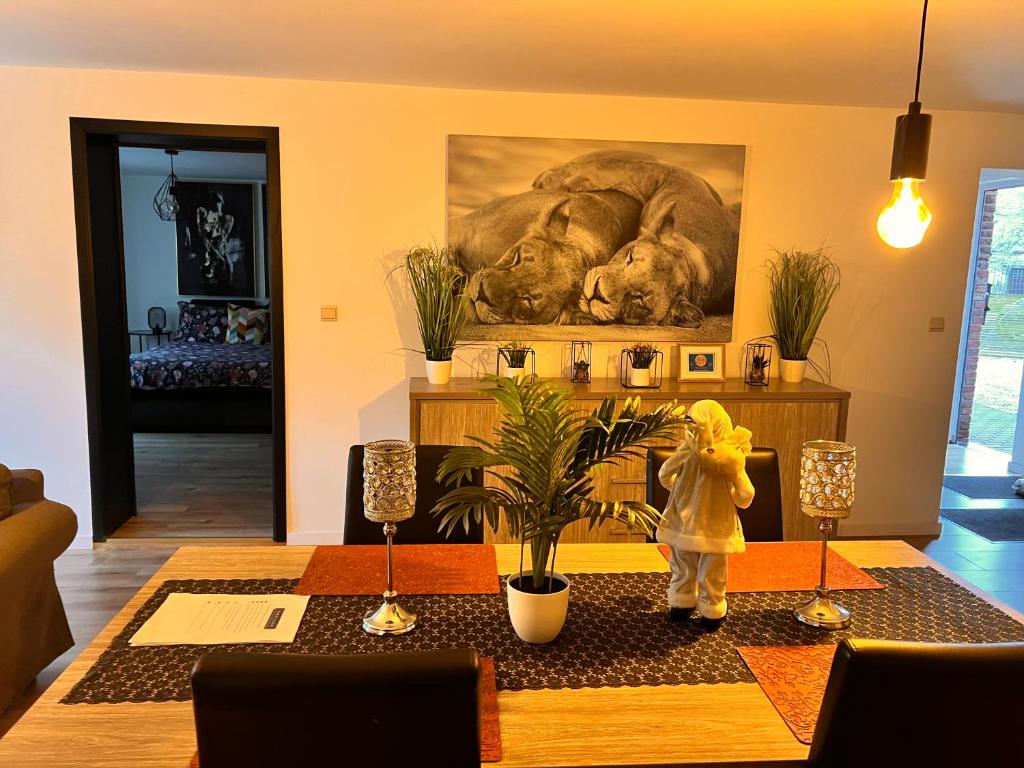 ein Esszimmer mit einem Tisch und einem Löwengemälde in der Unterkunft Résidence du Moulin 2-C-2 in Boussu