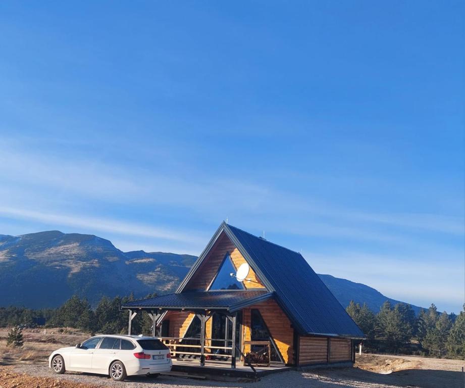 a house with a car parked in front of it at Vikendica Bulat in Blidinje